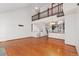 Bright, open-concept living room with hardwood floors, high ceilings, and a view of the kitchen at 9844 Fairwood St, Littleton, CO 80125