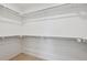 Walk-in closet with built-in shelving and carpet flooring, providing ample storage solutions at 28630 E 8Th St, Watkins, CO 80137