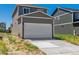 New construction home featuring a two-car garage and well-manicured lawn at 28630 E 8Th St, Watkins, CO 80137