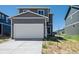 Two-car garage with concrete driveway in front of a two-story home at 28630 E 8Th St, Watkins, CO 80137