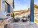Charming backyard patio features comfortable furniture, a built-in grill, and a beautiful view at 23327 E Ottawa Dr, Aurora, CO 80016