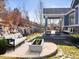 This backyard has a concrete fire pit, manicured lawn, and covered patio with ample seating at 23327 E Ottawa Dr, Aurora, CO 80016