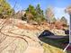 The backyard features a stone retaining wall, mature trees and a stone patio at 23327 E Ottawa Dr, Aurora, CO 80016
