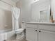 Bathroom featuring a tub with a shower, a toilet, a sink, and an ornate mirror at 23327 E Ottawa Dr, Aurora, CO 80016