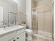 Clean bathroom featuring a vanity, a toilet, and a modern glass door shower at 23327 E Ottawa Dr, Aurora, CO 80016