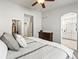 Bedroom featuring neutral walls and flooring with a glimpse into the ensuite bathroom at 23327 E Ottawa Dr, Aurora, CO 80016