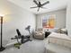Cozy bedroom featuring neutral walls and carpet, a ceiling fan, and a comfortable chair at 23327 E Ottawa Dr, Aurora, CO 80016