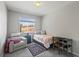 Bedroom featuring neutral colors, an armchair, a desk, and a beautiful outdoor view at 23327 E Ottawa Dr, Aurora, CO 80016