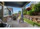 Enjoy the outdoors under the covered stone patio overlooking a serene stone garden and lush greenery at 23327 E Ottawa Dr, Aurora, CO 80016