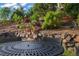Charming backyard dining area surrounded by lush landscaping, colorful flowers, and serene ambiance at 23327 E Ottawa Dr, Aurora, CO 80016