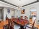 This bright dining room features wood floors and a statement chandelier at 23327 E Ottawa Dr, Aurora, CO 80016