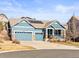Charming home features a three-car garage, covered porch, and professional landscaping at 23327 E Ottawa Dr, Aurora, CO 80016