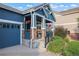Inviting front porch showcasing stone accents, hanging flower baskets, and a cozy seating area at 23327 E Ottawa Dr, Aurora, CO 80016