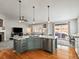 Kitchen island with stainless steel appliances and breakfast bar seating in a open floorplan at 23327 E Ottawa Dr, Aurora, CO 80016