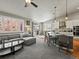 Open-concept living space with a comfortable gray sofa, modern lighting, and sliding doors to the outside at 23327 E Ottawa Dr, Aurora, CO 80016