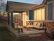 The covered patio has stone floors, plenty of seating and a view of the backyard at 23327 E Ottawa Dr, Aurora, CO 80016