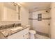 Bathroom showcasing tiled shower, white vanity, and updated fixtures at 9867 E Peakview Ave # E1, Englewood, CO 80111