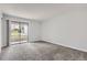 Carpeted bedroom with sliding glass door to the exterior at 9867 E Peakview Ave # E1, Englewood, CO 80111