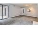 Living room showcasing access to balcony and a pass-through to the kitchen at 9867 E Peakview Ave # E1, Englewood, CO 80111