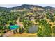 Aerial view of community with tennis courts and pond at 23636 Pondview Pl # C, Golden, CO 80401