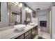 Elegant bathroom with double sinks, marble countertops, and large mirrors at 23636 Pondview Pl # C, Golden, CO 80401