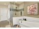 Bright bathroom with soaking tub, glass shower, and neutral color palette at 10112 Bluffmont Ln, Lone Tree, CO 80124