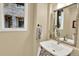 Charming powder room boasting a pedestal sink, decorative mirror, and natural light at 10112 Bluffmont Ln, Lone Tree, CO 80124