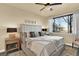 Bedroom with ceiling fan, neutral paint, large window with lots of natural light, and carpet at 10112 Bluffmont Ln, Lone Tree, CO 80124