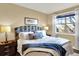Comfortable bedroom with a paisley headboard, a large window, and soft, inviting bedding at 10112 Bluffmont Ln, Lone Tree, CO 80124