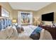 Bright bedroom with a large window, ample closet space, and stylish furnishings at 10112 Bluffmont Ln, Lone Tree, CO 80124