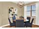 Dining room with modern chandelier, large window with blinds, and seating for six at 10112 Bluffmont Ln, Lone Tree, CO 80124
