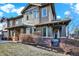 Charming home featuring a mix of shake siding, brick accents, and inviting front porch at 10112 Bluffmont Ln, Lone Tree, CO 80124