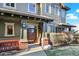 Inviting covered porch with brick columns and stylish lighting welcomes you to the home at 10112 Bluffmont Ln, Lone Tree, CO 80124