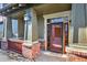 Close-up of the front porch featuring brick accents, stylish lighting, and the front door at 10112 Bluffmont Ln, Lone Tree, CO 80124