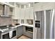 Kitchen includes stainless steel appliances, white cabinets, and tile backsplash at 10112 Bluffmont Ln, Lone Tree, CO 80124