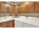 Well-equipped laundry room featuring updated washer, dryer, and ample cabinet space at 10112 Bluffmont Ln, Lone Tree, CO 80124