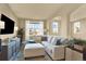 Comfortable living room featuring a large sectional sofa, a media center, and ample natural light at 10112 Bluffmont Ln, Lone Tree, CO 80124