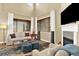 Bright living room with fireplace, TV, plush seating, and large windows with coverings at 10112 Bluffmont Ln, Lone Tree, CO 80124