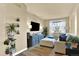 Cozy living room with plush seating, a large television, and stylish decor at 10112 Bluffmont Ln, Lone Tree, CO 80124