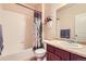 Bathroom features tub/shower combo, vanity with storage, and neutral color palette at 15362 W 66Th Ave # D, Arvada, CO 80007