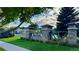 Stone entrance to Hometown neighborhood with lush landscaping and welcoming atmosphere under a partly cloudy sky at 15362 W 66Th Ave # D, Arvada, CO 80007
