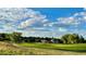Scenic view of the golf course surrounded by lush greenery and mature trees in a tranquil and picturesque setting at 15362 W 66Th Ave # D, Arvada, CO 80007