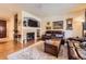 Inviting living room space with stone fireplace, mounted tv and hardwood flooring at 15362 W 66Th Ave # D, Arvada, CO 80007