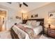 Spacious main bedroom features a ceiling fan, dresser, and ample natural light at 15362 W 66Th Ave # D, Arvada, CO 80007