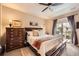 Spacious main bedroom features a ceiling fan, dresser, and balcony access at 15362 W 66Th Ave # D, Arvada, CO 80007