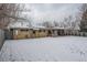 Generous backyard with partial fencing and a covered patio, offering a private and inviting outdoor space at 306 S Newport Way, Denver, CO 80224