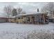 Spacious backyard featuring a covered patio area, ideal for enjoying outdoor living and entertaining guests at 306 S Newport Way, Denver, CO 80224