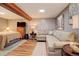 Cozy basement with a sectional sofa and laminate floors, perfect for relaxing and enjoying at 306 S Newport Way, Denver, CO 80224