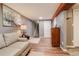 Basement living space featuring a sofa and stairs to the upper level with vinyl floors at 306 S Newport Way, Denver, CO 80224