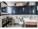 Stylish bathroom featuring dark blue tiled walls and elegant marble countertops and hexagon tiled floors at 306 S Newport Way, Denver, CO 80224